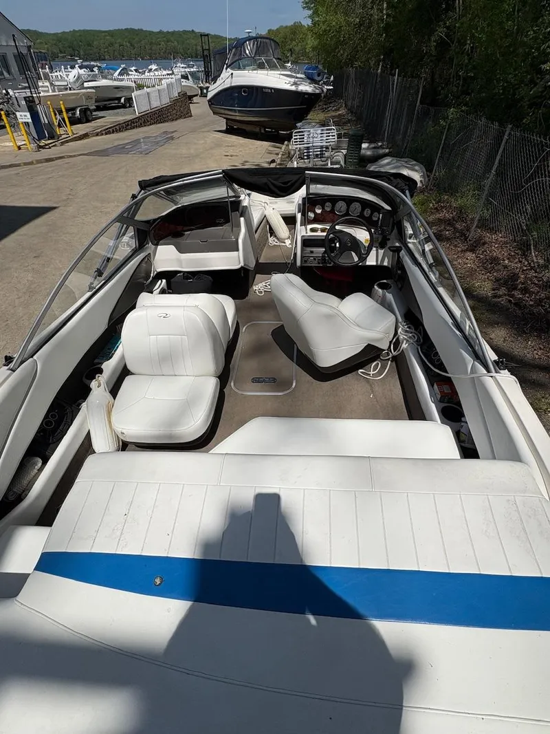 Slide: The Image of 2005 Regal 1800 Bowrider boat with white interior, docked outdoors. - 7