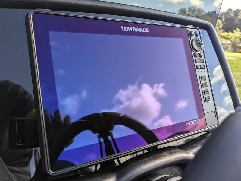 Slide: The Image of Lowrance display on Falcon F20 PREDATOR 2025 boat, reflecting blue sky and clouds. - 14