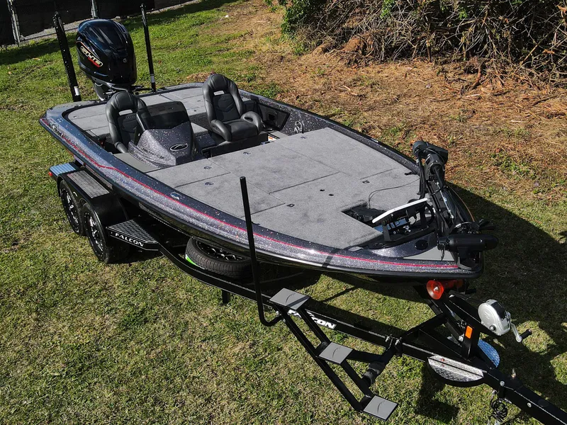Slide: The Image of 2025 Falcon F20 PREDATOR fishing boat on trailer, parked on grass. - 17