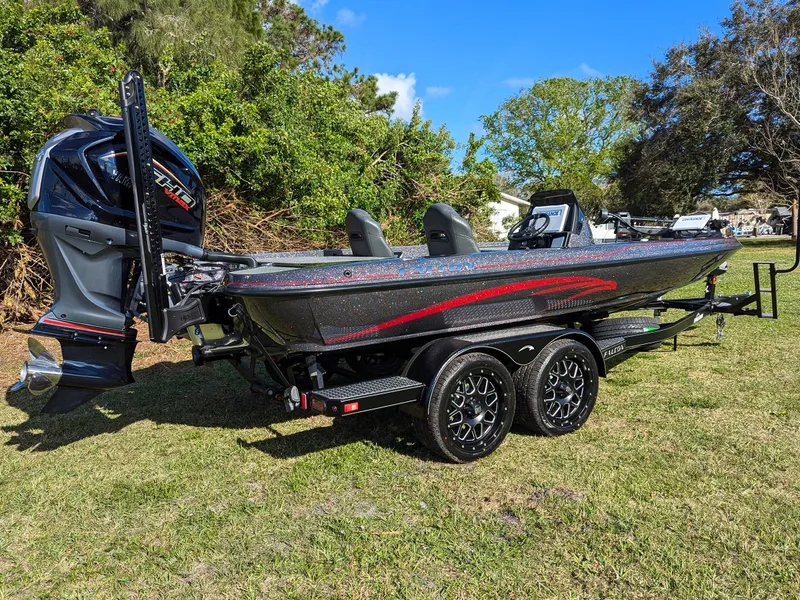 Slide: The Image of 2025 Falcon F20 PREDATOR boat on trailer, parked on grass, with trees in background. - 4