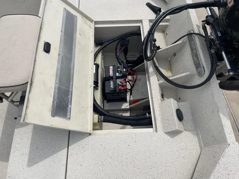 Slide: The Image of 2017 Alumacraft 1860 BAY CC TUNNEL boat battery compartment with wiring and motor connections. - 16