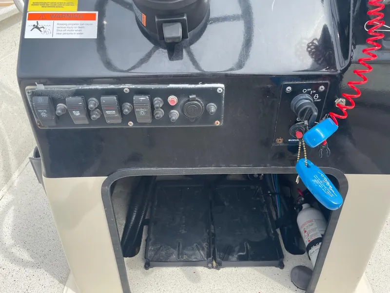 Slide: The Image of Control panel of a 2017 Alumacraft 1860 BAY CC TUNNEL boat with switches and ignition. - 19