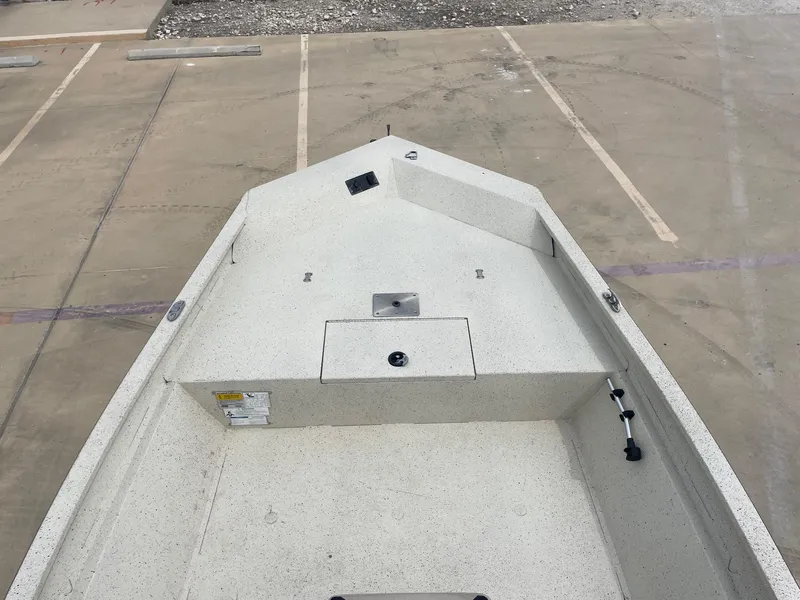 Slide: The Image of 2017 Alumacraft 1860 BAY CC TUNNEL boat deck, spacious and clean, in a parking area. - 26