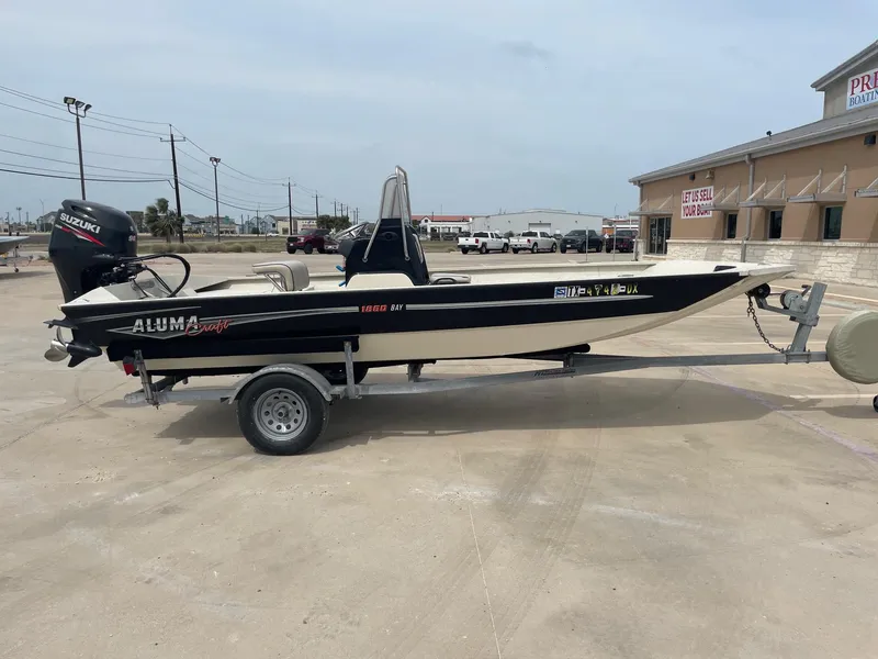 Slide: The Image of 2017 Alumacraft 1860 BAY CC TUNNEL boat on trailer, parked outdoors. - 7