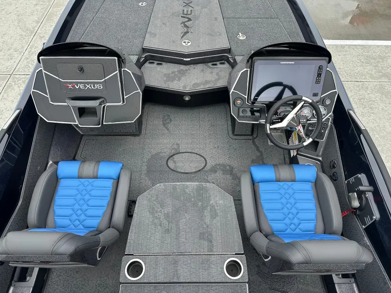Slide: The Image of 2025 Vexus VXS21 boat interior with blue and gray seating, modern dashboard, and steering wheel. - 12