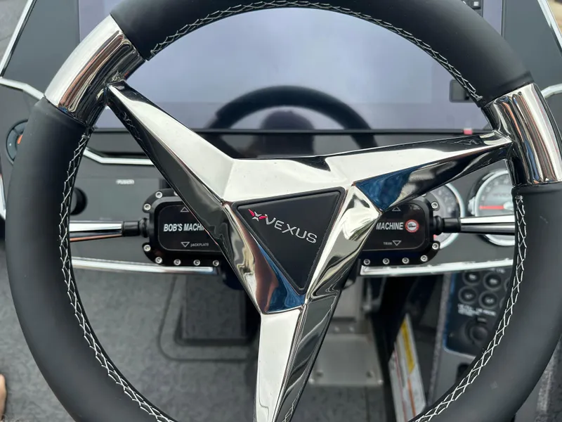 Slide: The Image of Steering wheel of 2025 Vexus VXS21 boat with modern dashboard controls. - 18