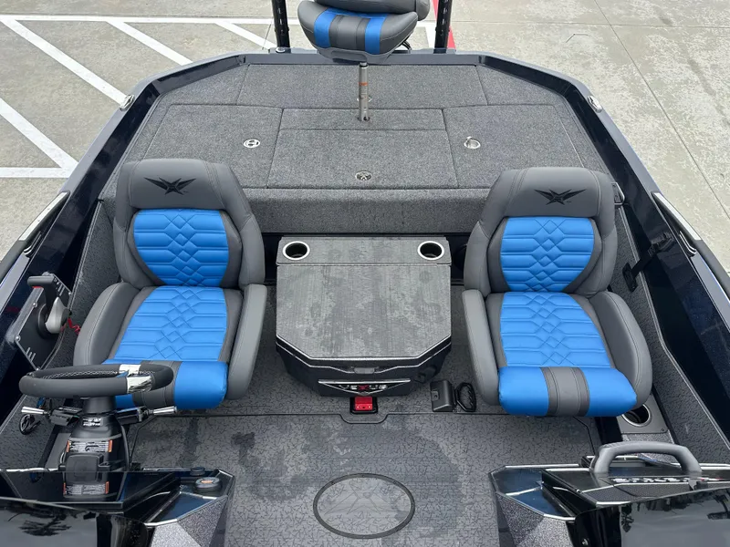 Slide: The Image of 2025 Vexus VXS21 boat interior with blue and gray seating, steering wheel, and storage compartments. - 22