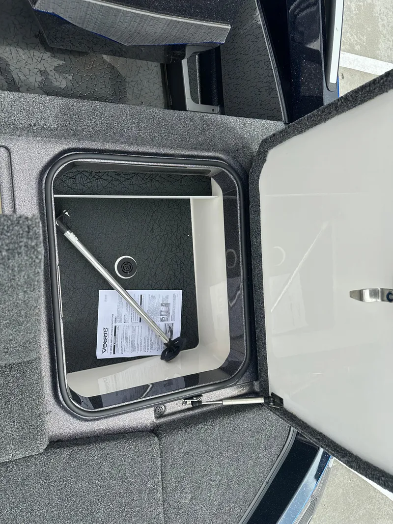 Slide: The Image of Open storage compartment in a 2025 Vexus VXS21 boat, showing interior details. - 25