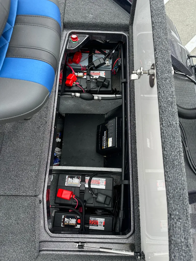 Slide: The Image of Battery compartment of 2025 Vexus VXS21 boat, featuring Pro Guide batteries and wiring. - 27