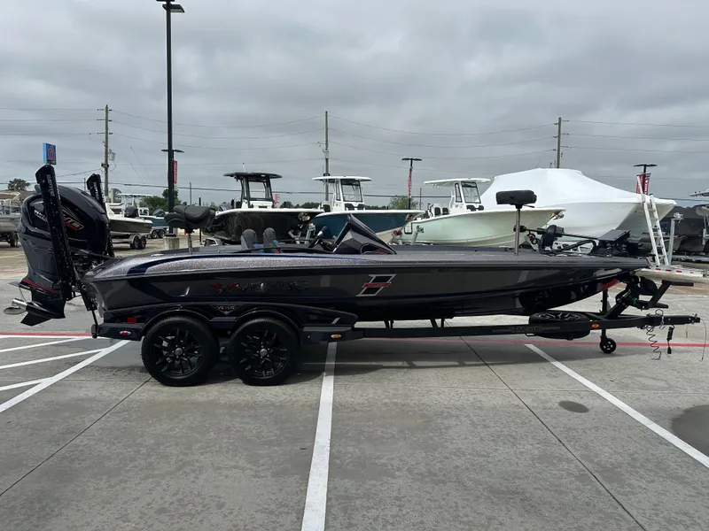 Slide: The Image of 2025 Vexus VXS21 boat on trailer in parking lot, overcast sky. - 28