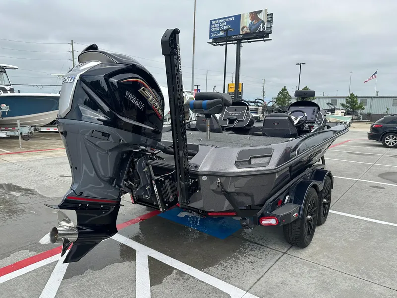Slide: The Image of 2025 Vexus VXS21 boat with powerful outboard motor in a parking lot. - 29