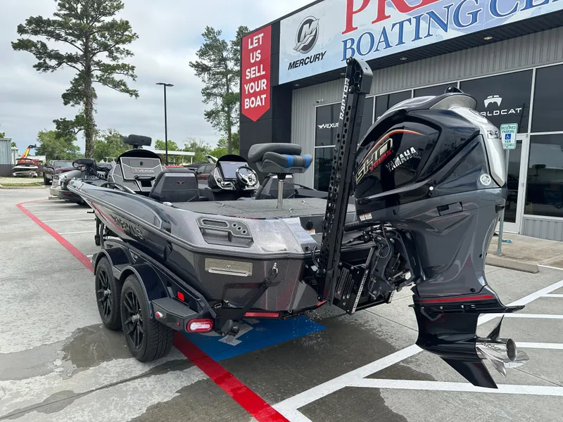 Slide: The Image of 2025 Vexus VXS21 boat with Yamaha engine at dealership parking lot. - 31