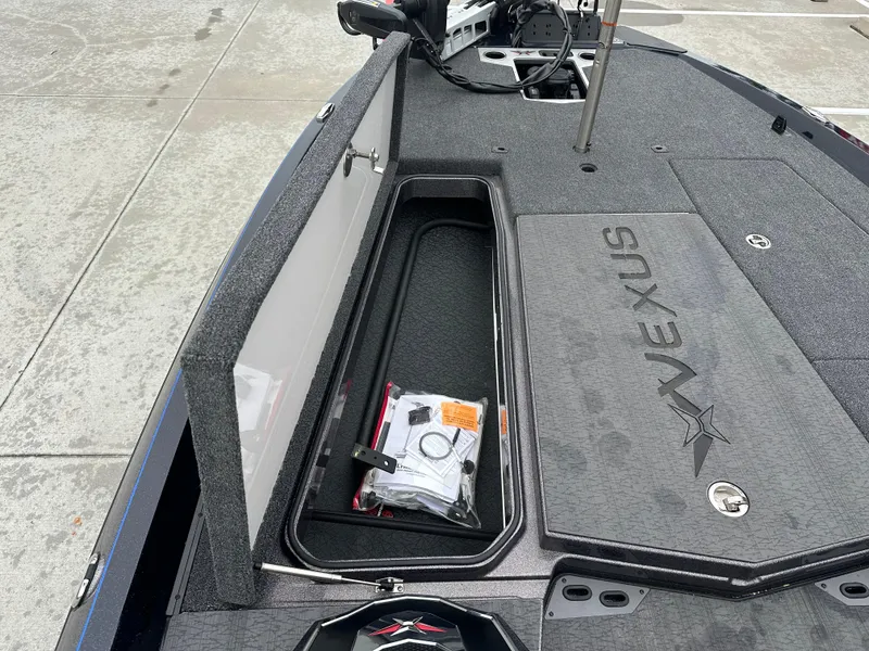 Slide: The Image of 2025 Vexus VXS21 boat storage compartment with open lid, showcasing interior space and accessories. - 6