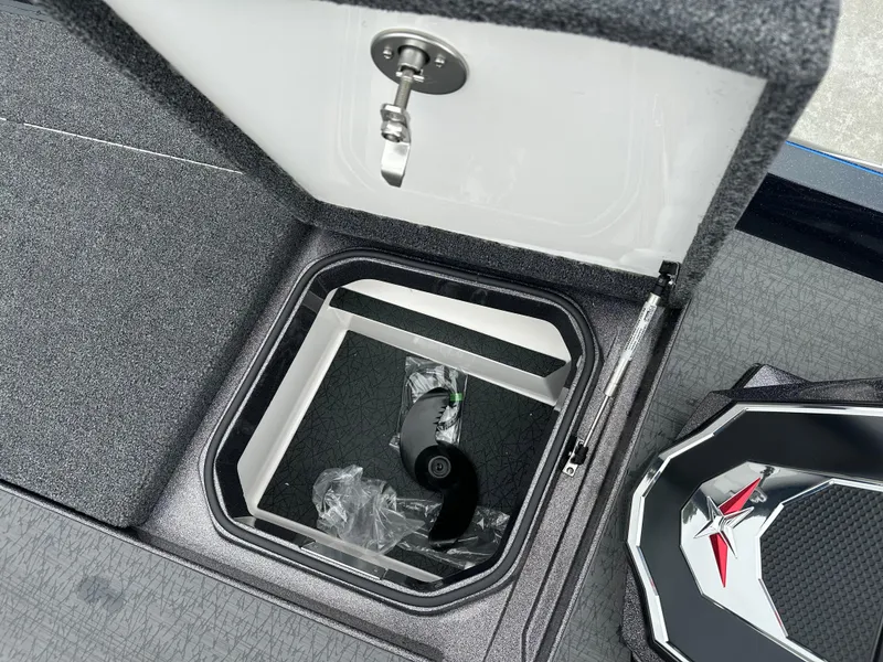 Slide: The Image of Open storage compartment in 2025 Vexus VXS21 boat, featuring secure latch and modern design. - 7