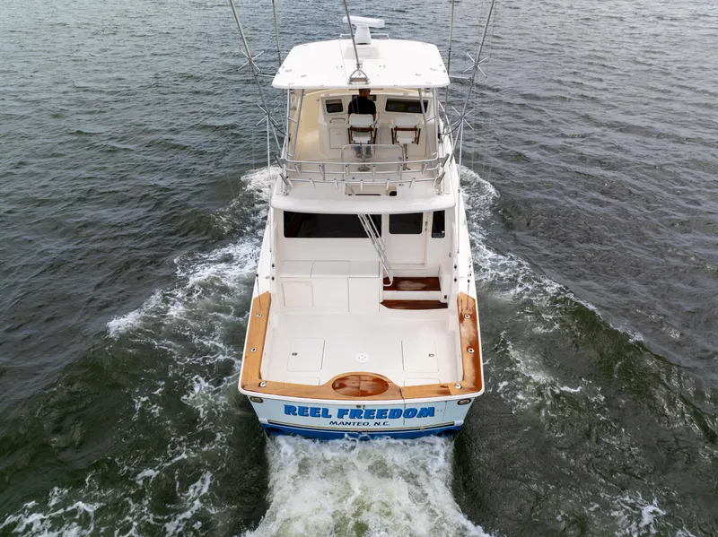 Slide: The Image of 2004 Ocean Yachts 50 Super Sport cruising on open water, rear view. - 10