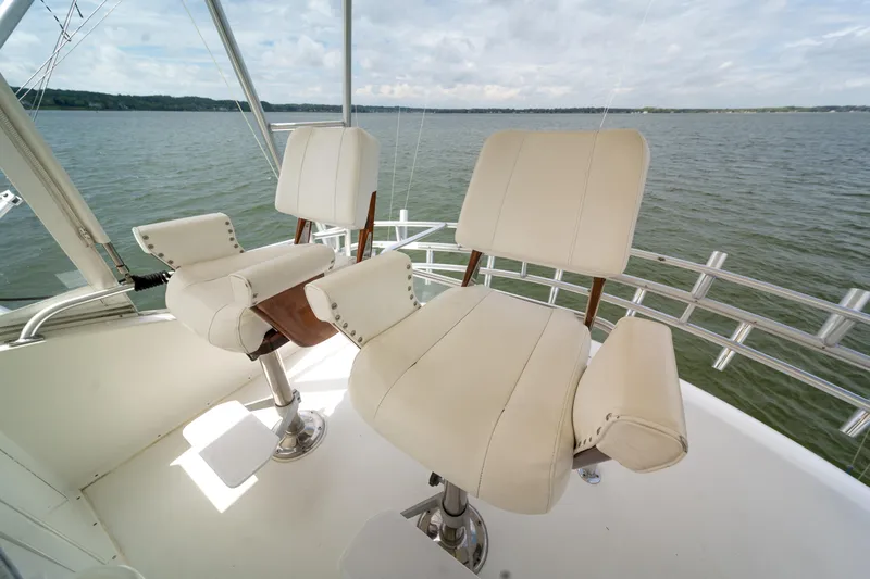 Slide: The Image of 2004 Ocean Yachts 50 Super Sport helm chairs overlooking serene waters. - 18