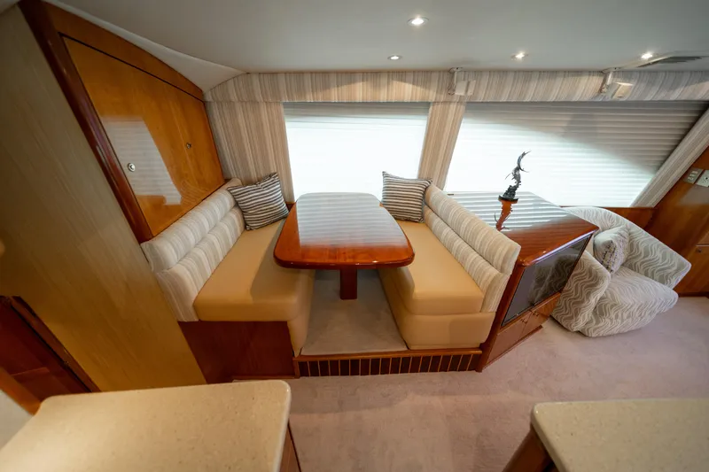 Slide: The Image of Interior of 2004 Ocean Yachts 50 Super Sport with cozy dining area and plush seating. - 28