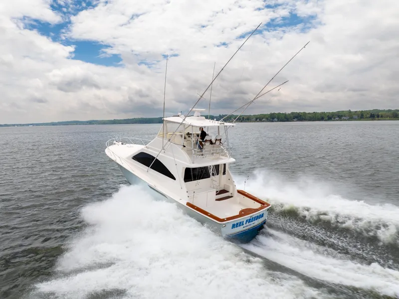 Slide: The Image of 2004 Ocean Yachts 50 Super Sport cruising on open water under cloudy skies. - 3