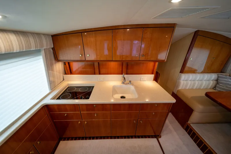 Slide: The Image of Luxurious kitchen interior of 2004 Ocean Yachts 50 Super Sport with wood cabinetry and modern appliances. - 34