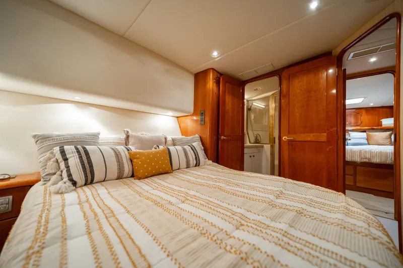Slide: The Image of Luxurious bedroom interior of 2004 Ocean Yachts 50 Super Sport with cozy bedding and wooden accents. - 38