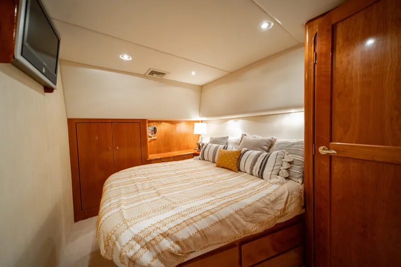 Slide: The Image of Luxurious cabin interior of 2004 Ocean Yachts 50 Super Sport with cozy bedding and wood finishes. - 39