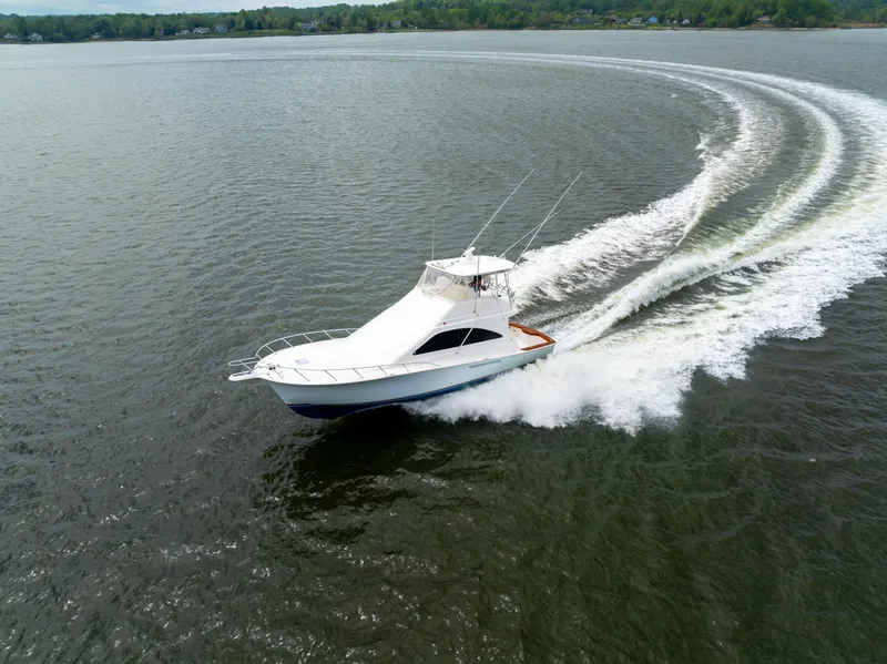 Slide: The Image of 2004 Ocean Yachts 50 Super Sport cruising on open water, creating a dynamic wake. - 4