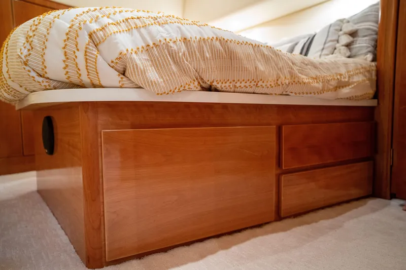 Slide: The Image of 2004 Ocean Yachts 50 Super Sport bedroom with wooden storage bed and cozy bedding. - 40