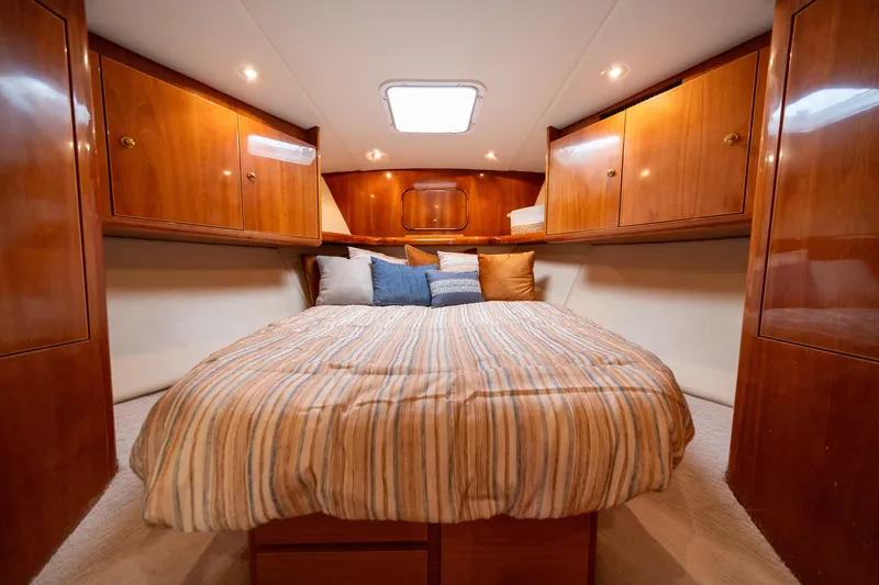 Slide: The Image of Luxurious cabin interior of 2004 Ocean Yachts 50 Super Sport with wood finish and cozy bedding. - 43