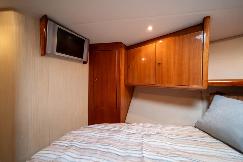 Slide: The Image of 2004 Ocean Yachts 50 Super Sport cabin with wood cabinetry and cozy bed. - 44