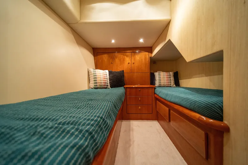 Slide: The Image of 2004 Ocean Yachts 50 Super Sport cabin with twin beds and wooden cabinetry. - 51