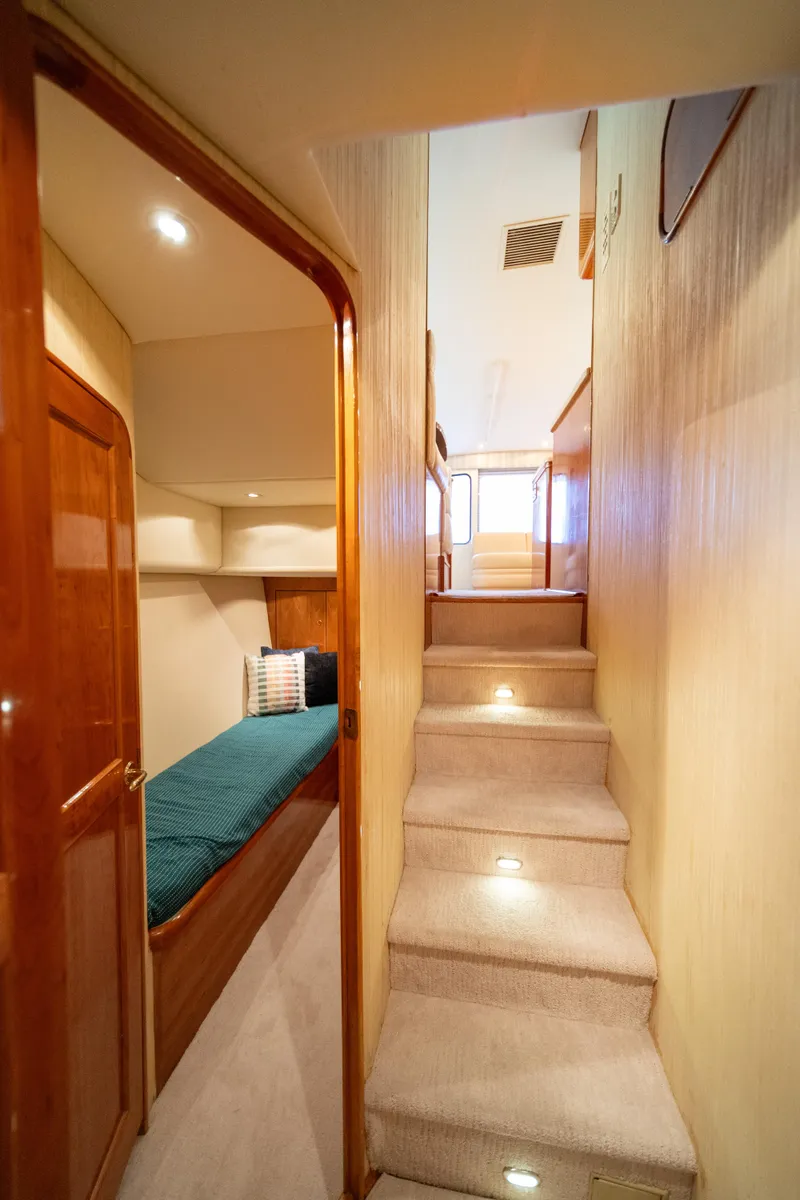 Slide: The Image of Interior view of 2004 Ocean Yachts 50 Super Sport, featuring stairs and cozy cabin. - 53