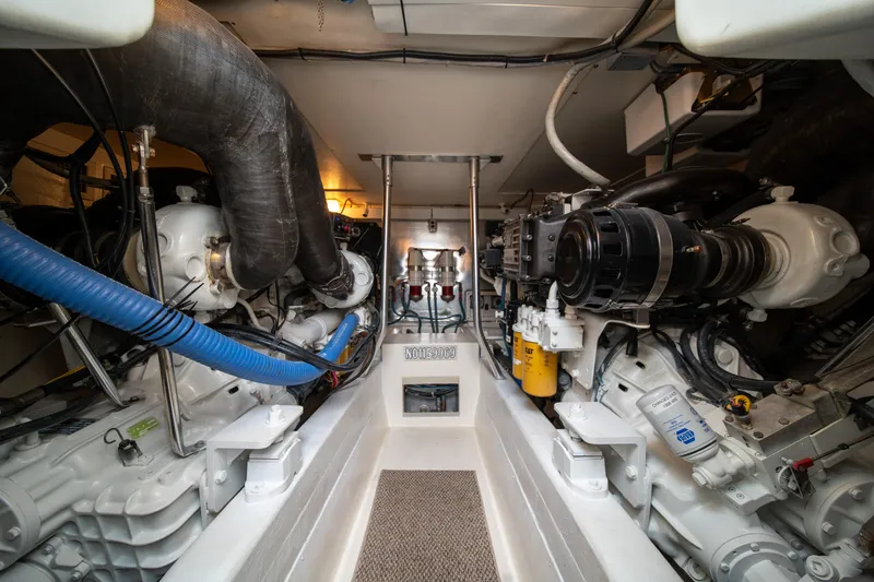 Slide: The Image of Engine room of a 2004 Ocean Yachts 50 Super Sport, showcasing mechanical components. - 54
