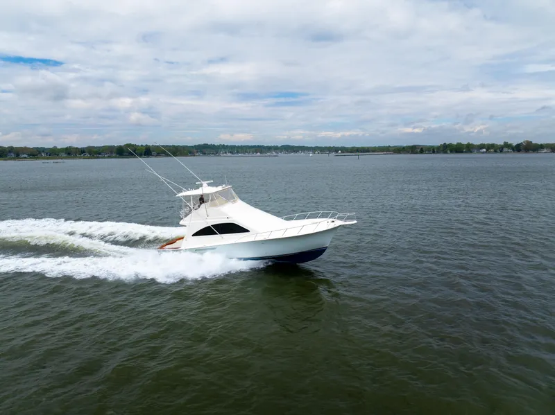 Slide: The Image of 2004 Ocean Yachts 50 Super Sport cruising on open water under a cloudy sky. - 6