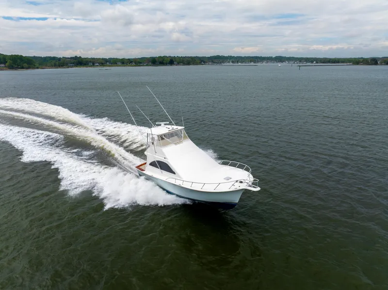 Slide: The Image of 2004 Ocean Yachts 50 Super Sport cruising on open water, creating a dynamic wake. - 7