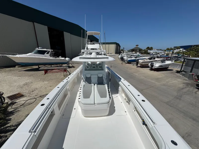 Slide: The Image of 2022 Invincible 46 Catamaran docked at a marina under clear blue skies. - 10