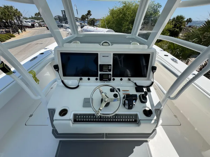 Slide: The Image of 2022 Invincible 46 Catamaran helm with dual screens and steering wheel. - 12
