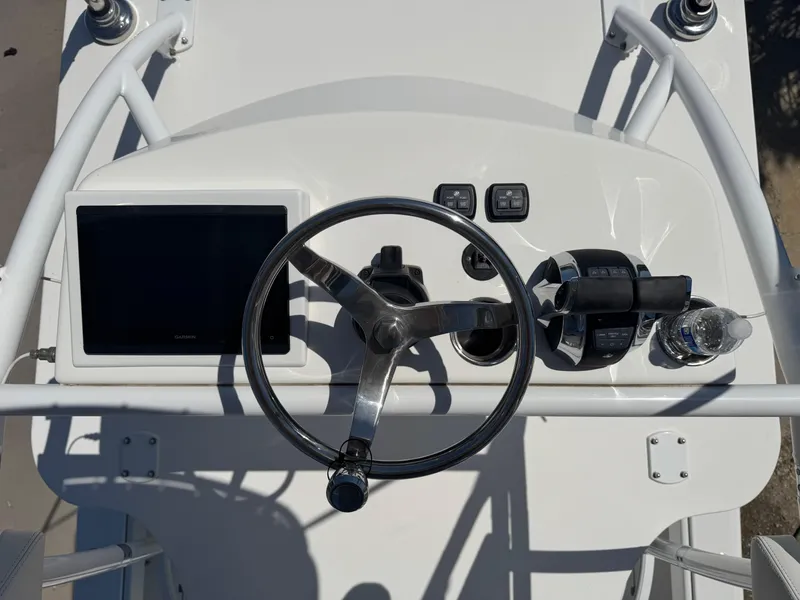 Slide: The Image of Helm of 2022 Invincible 46 Catamaran with steering wheel and navigation controls. - 13