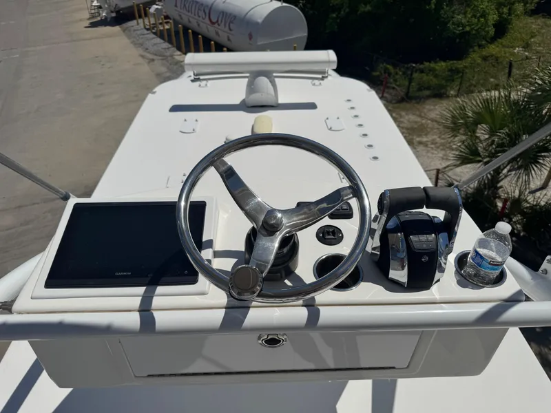 Slide: The Image of Invincible 46 Catamaran 2022 helm with steering wheel, controls, and navigation screen. - 14