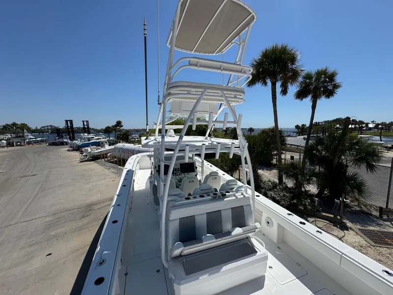Slide: The Image of 2022 Invincible 46 Catamaran on dock, featuring elevated seating and clear blue sky. - 3