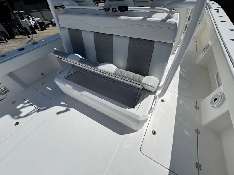 Slide: The Image of 2022 Invincible 46 Catamaran with open storage compartment and sleek seating design. - 4