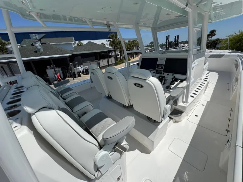 Slide: The Image of 2022 Invincible 46 Catamaran cockpit with modern seating and navigation controls. - 6