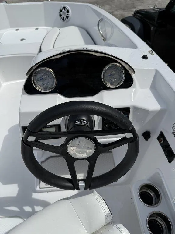 Slide: The Image of 2025 Stingray 182SC boat dashboard with steering wheel and gauges. - 12