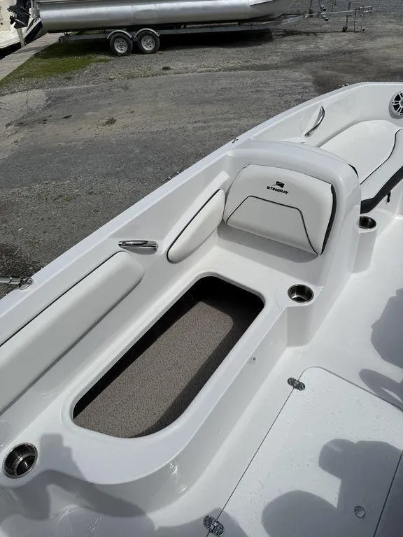Slide: The Image of 2025 Stingray 182SC boat interior with white seating and storage compartment. - 13