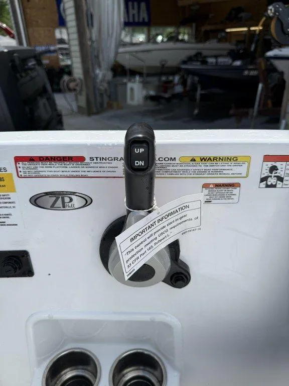 Slide: The Image of Control panel of a 2025 Stingray 182SC boat with warning labels and instructions. - 16