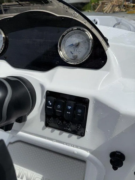 Slide: The Image of Dashboard of a 2025 Stingray 182SC boat with gauges and control switches. - 18