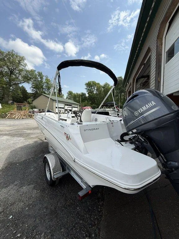 Slide: The Image of 2025 Stingray 182SC boat with Yamaha engine on trailer, parked outdoors. - 4