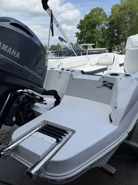 Slide: The Image of 2025 Stingray 182SC boat with Yamaha outboard motor and swim platform ladder. - 7