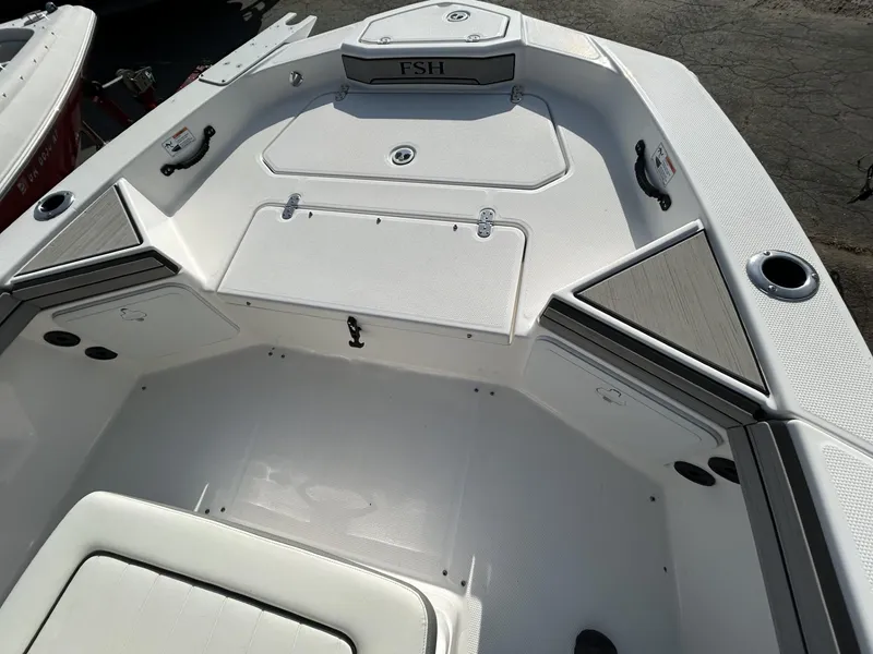 Slide: The Image of 2021 Yamaha Boats 195 FSH Sport interior, featuring spacious deck and storage compartments. - 10