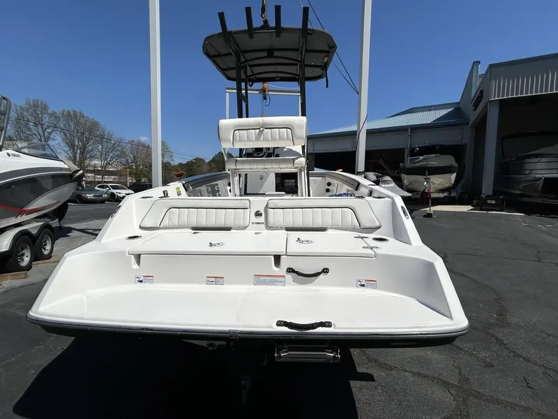 Slide: The Image of 2021 Yamaha Boats 195 FSH Sport, rear view, in a marina setting. - 3