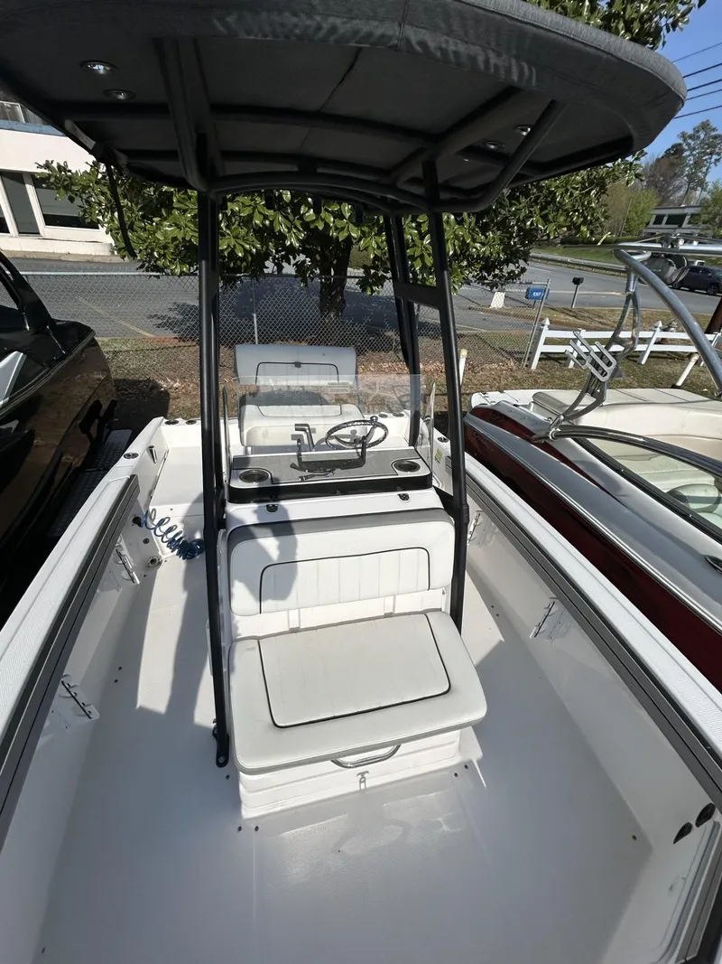 Slide: The Image of 2021 Yamaha Boats 195 FSH Sport interior with seating and console, featuring a sleek design. - 8